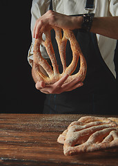 Image showing Baker\'s hands hold fougas bread