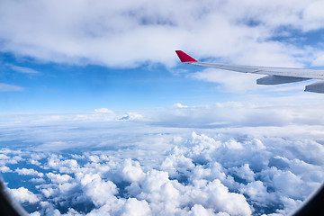 Image showing Clouds and sky as seen through window of an aircraft