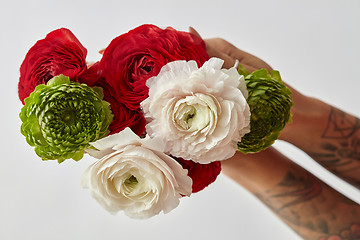 Image showing girl with a tattoo on her hands holding a bouquet of flowers