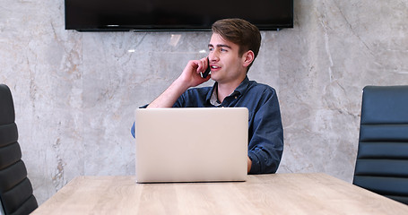 Image showing businessman working using a laptop in startup office