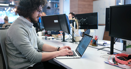 Image showing businessman working using a laptop in startup office