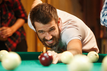 Image showing Close-up shot of a man playing billiard