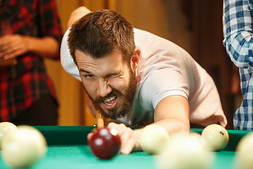 Image showing Close-up shot of a man playing billiard