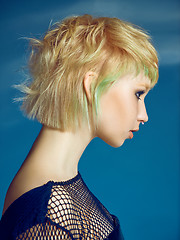 Image showing Close-up indoor portrait of lovely girl with blonde hair. Studio shot of graceful young woman with short haircut