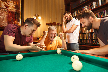 Image showing The displeased men playing billiards at office after work.