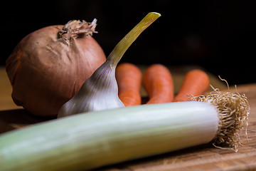 Image showing onion, leek, garlic and carots on a table