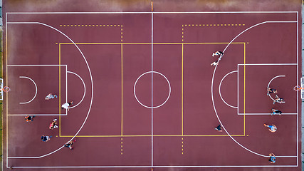 Image showing Basketball court with players and ball. Sports game in basketball. View strictly from above with the drone.