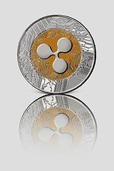 Image showing Coin ripple on white glossy background. Conceptual image for worldwide cryptocurrency and digital payment system.