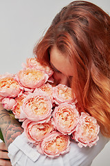 Image showing pretty girl holding a bouquet of pink roses