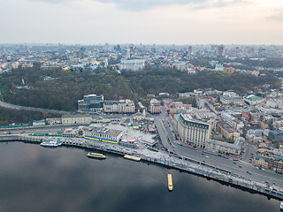 Image showing The panoramic bird\'s eye view shooting from drone of the Podol district, the right bank of the Dnieper River and centre of Kiev, Ukraine summer evening at sunset on the background of the cloudy sky.