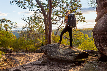 Image showing Female bushwalker with backpack walking in Australian bushland