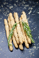 Image showing Italian grissini or salted bread sticks with sesame and rosemary