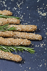 Image showing Italian grissini or salted bread sticks with sesame and rosemary