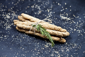 Image showing Italian grissini or salted bread sticks with sesame and rosemary