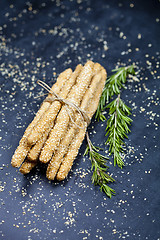 Image showing Italian grissini or salted bread sticks with sesame and rosemary