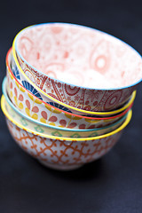 Image showing Stack of colorful empty ceramic bowls closeup.