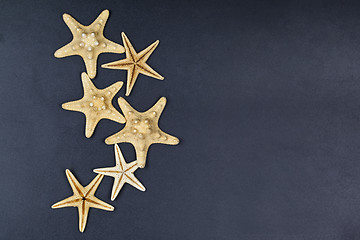 Image showing Top view of five starfish on black background.