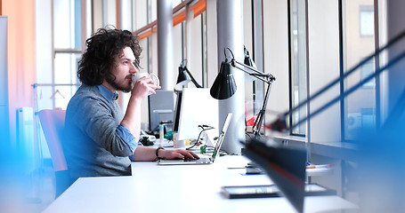 Image showing businessman working using a laptop in startup office