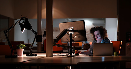 Image showing man working on computer in dark office