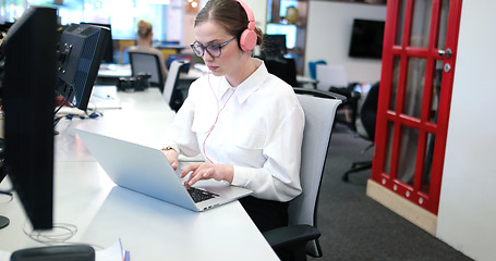 Image showing businesswoman using a laptop in startup office