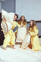 Image showing The group of girlfriends taking goog time on bed