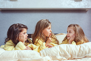 Image showing The group of girlfriends taking goog time on bed
