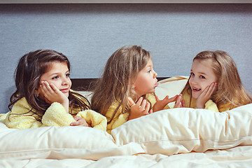 Image showing The group of girlfriends taking goog time on bed