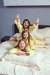 Image showing The group of girlfriends taking goog time on bed