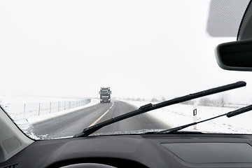 Image showing View from a car to road with snow