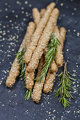 Image showing Italian grissini or salted bread sticks with sesame and rosemary