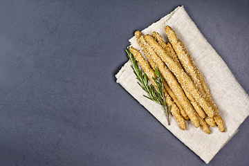 Image showing Italian grissini or salted bread sticks with sesame and rosemary