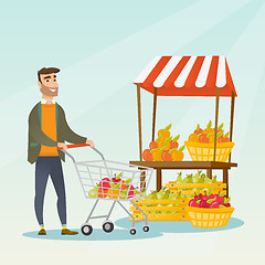 Image showing Young caucasian man pushing a supermarket cart.