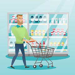 Image showing Young caucasian man with supermarket trolley.