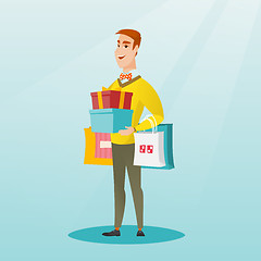 Image showing Caucasian man holding shopping bags and gift boxes