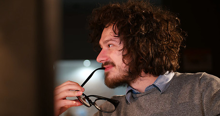 Image showing man working on computer in dark office