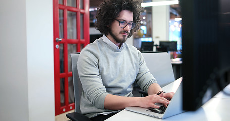 Image showing businessman working using a laptop in startup office