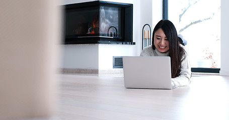 Image showing Asian woman using laptop on floor