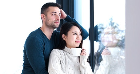 Image showing multiethnic couple relaxing at modern home indoors