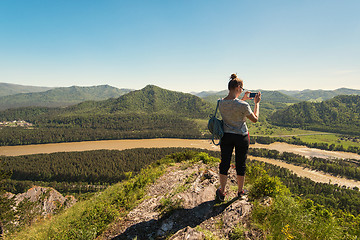 Image showing Woman taking photo in mountain