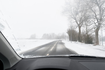 Image showing View from a car to road with snow