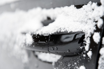 Image showing closeup of a doorknob of a car with snow