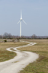 Image showing Windmill by a winding country road