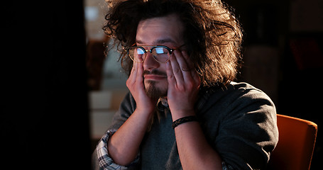 Image showing man working on computer in dark office