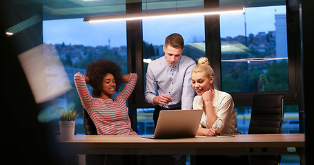 Image showing Multiethnic startup business team in night office