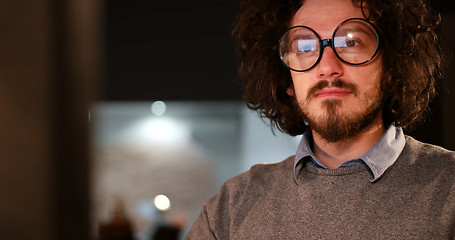 Image showing man working on computer in dark office