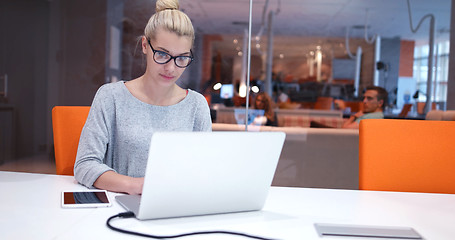 Image showing businesswoman using a laptop in startup office