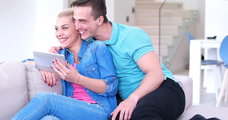 Image showing couple relaxing at  home with tablet computers