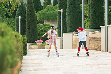 Image showing Portrait of a charming teenage couple roller-skating together