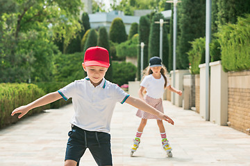 Image showing Portrait of a charming teenage couple roller-skating together