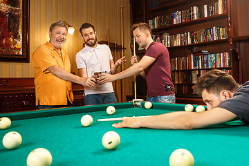 Image showing Close-up shot of a man playing billiard